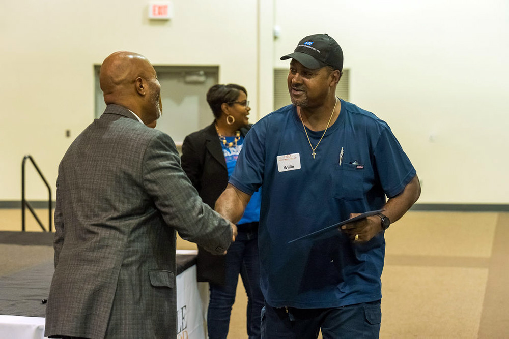 Two men shaking hands at a graduation